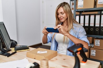 Young blonde woman ecommerce business worker make photo to package order at office