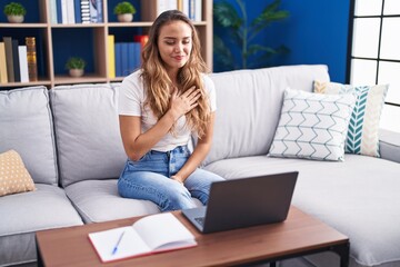 Young beautiful hispanic woman having video call communicate with sign deaf language at home