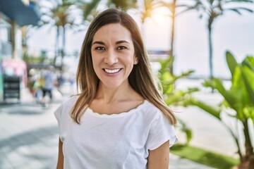 Fototapeta premium Young hispanic woman smiling confident at street
