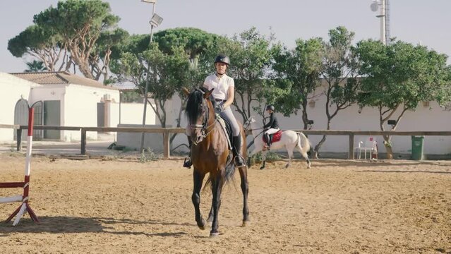 4K video of a young rider performing equestrian dressage exercises at a riding school