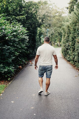 Fototapeta premium Lonely man passing time in a park