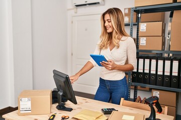 Young blonde woman ecommerce business worker using touchpad working at office