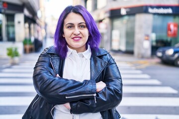 Young beautiful plus size woman standing with arms crossed gesture at street