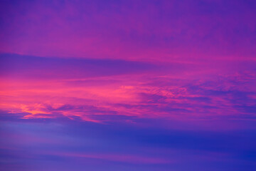 Naklejka na ściany i meble Vivid saturated beautiful sunset sky in pink, purple and blue colors. Abstract amazing sunset background