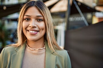 Young latin woman smiling confident at street