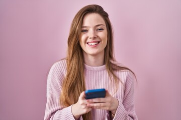 Young caucasian woman using smartphone typing message smiling and laughing hard out loud because funny crazy joke.