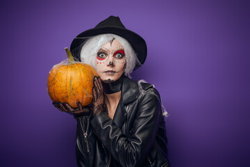Scared surprised witch with grey hair on Halloween