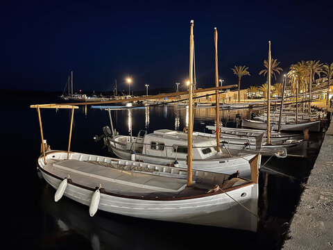 typical balearic boats, mallorcan or Menorcan boats, llauts, moored at night in the harbor of a small village, Fornells, Menorca, Balearic Islands, Spain