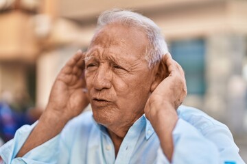 Senior grey-haired man suffering for no listening at street