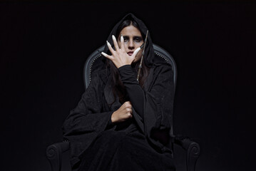 Witch sitting on her dark throne, casting spells, looking creepy and sinister, halloween, magic and...