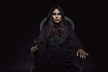 Witch sitting on her dark throne, casting spells, looking creepy and sinister, halloween, magic and...