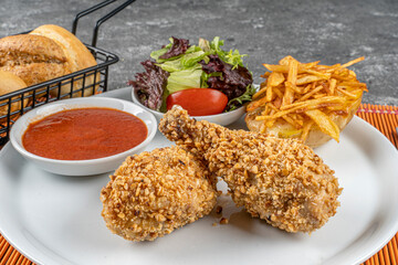 Crispy Fried Chicken Drumsticks,Fried Chicken served with potatoes, salad and bread.