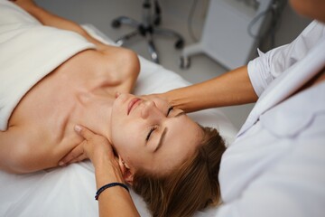 Obraz na płótnie Canvas Face massage. Young pretty woman having face massage in the salon