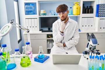 Young arab man scientist having video call working at laboratory