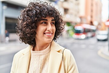 Young middle east woman excutive smiling confident looking to the side at street