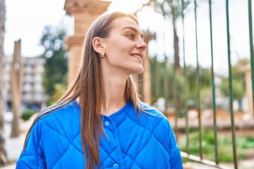 Young caucasian woman smiling confident looking to the side at street