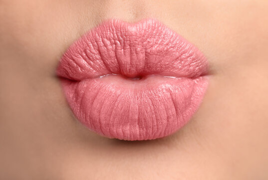 Closeup view of beautiful woman puckering lips for kiss