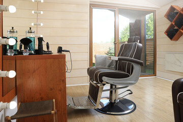 Stylish hairdresser's workplace with professional armchair in barbershop