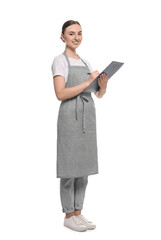 Beautiful young woman in clean apron with clipboard on white background