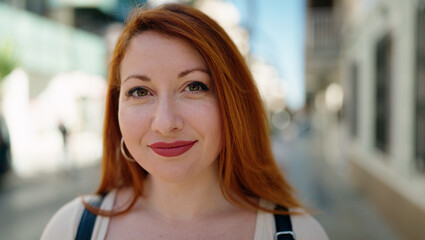 Young redhead woman smiling confident standing at street