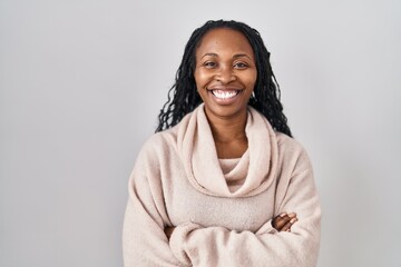 African woman standing over white background happy face smiling with crossed arms looking at the camera. positive person.