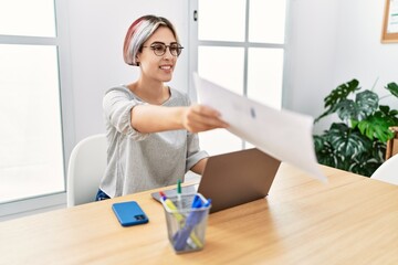 Young caucasian businesswoman using laptop working at the office.