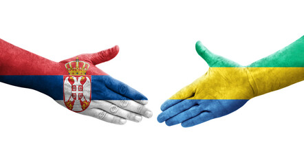 Handshake between Gabon and Serbia flags painted on hands, isolated transparent image.