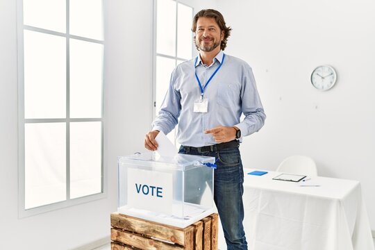 Middle Age Caucasian Man Smiling Confident Voting At Electoral College