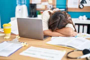 Young beautiful hispanic woman business worker leaning on table sleeping at office