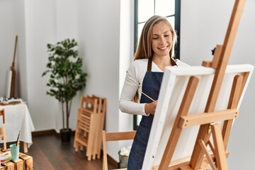 Young caucasian woman smiling confident drawing at art studio