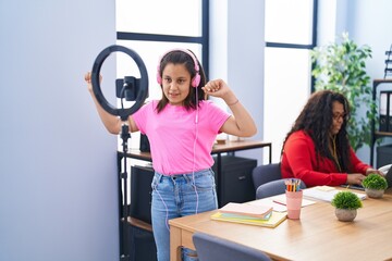 Mother and daughter working and recording dance video at office
