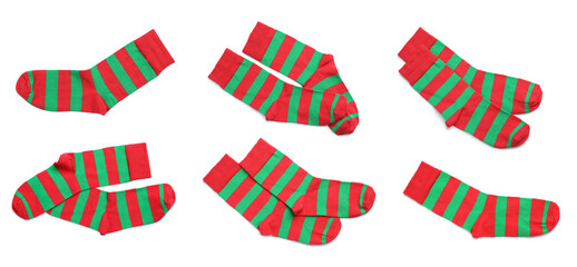 Set with pairs of striped socks on white background, top view. Banner design