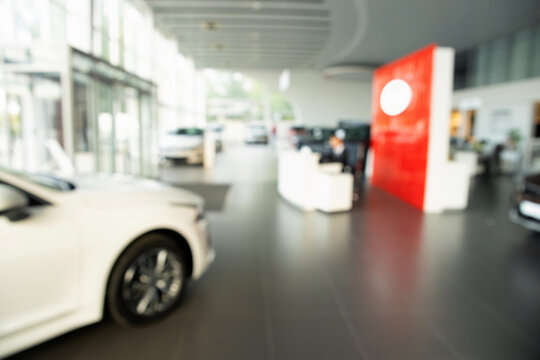 New cars at dealer showroom blurred background