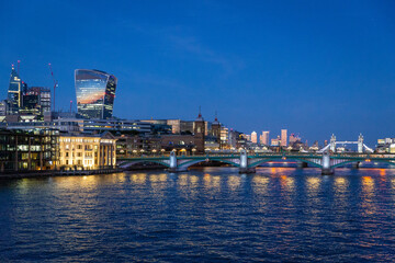 london skyline at sunset along the thames river