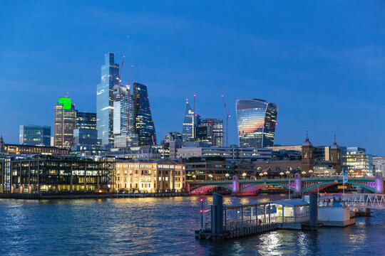 london skyline at sunset along the thames river