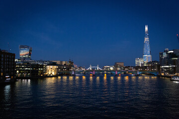london bridge and shard, skyline at sunset along the thames river