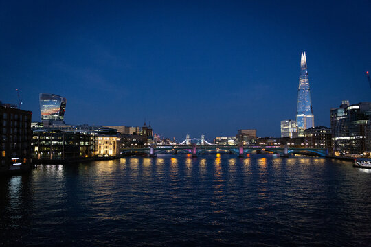 london bridge and shard, skyline at sunset along the thames river
