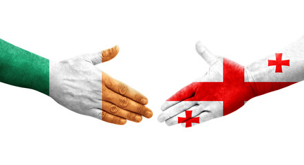 Handshake between Georgia and Ireland flags painted on hands, isolated transparent image.