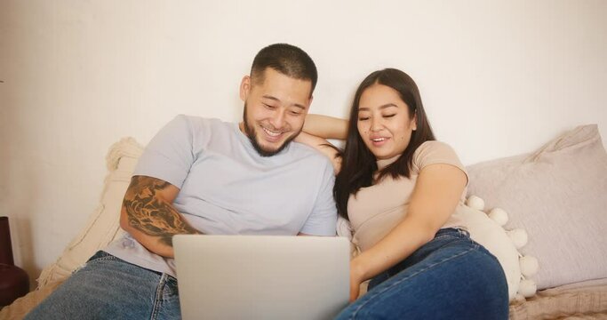 Asian couple watches movie and discusses topics together