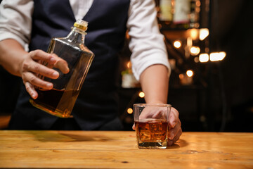 Barman pouring whiskey whiskey glass beautiful night