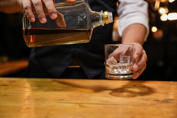 Barman pouring whiskey whiskey glass beautiful night