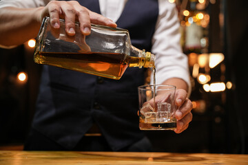 Barman pouring whiskey whiskey glass beautiful night