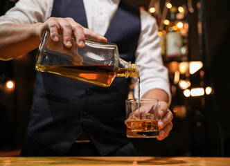 Barman pouring whiskey whiskey glass beautiful night