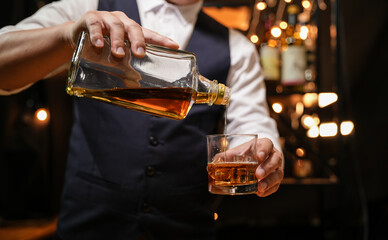 Barman pouring whiskey whiskey glass beautiful night