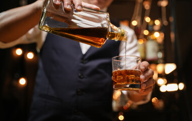 Barman pouring whiskey whiskey glass beautiful night