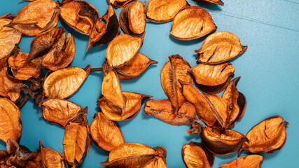 Dried orange autumn leaves on blue background