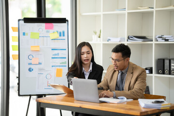 Group of young Asian business people or creative team in brainstorm discussion meeting in office.