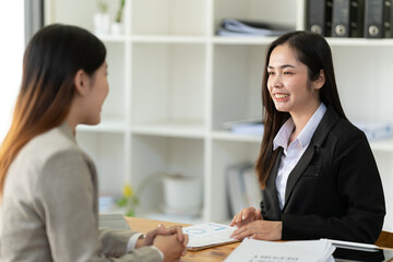 Two Young Asian businesswoman discuss with new startup project Idea presentation.