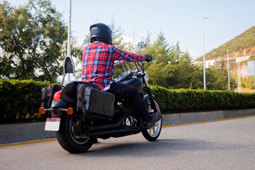 Biker man riding a motorcycle on the street