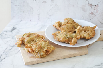 Bakwan goreng, fried food, Indonesian traditional street food snacks. fried vegetables dough fritters, appetizer on a white plate